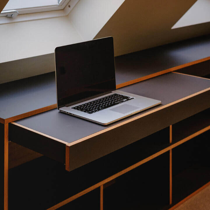 Bespoke Home Office Pull-out Desk and Fitted Workspace Design Bespoke minimalist pull-out desk within a custom built unit with open shelving. By Fundi Joinery in Scotland