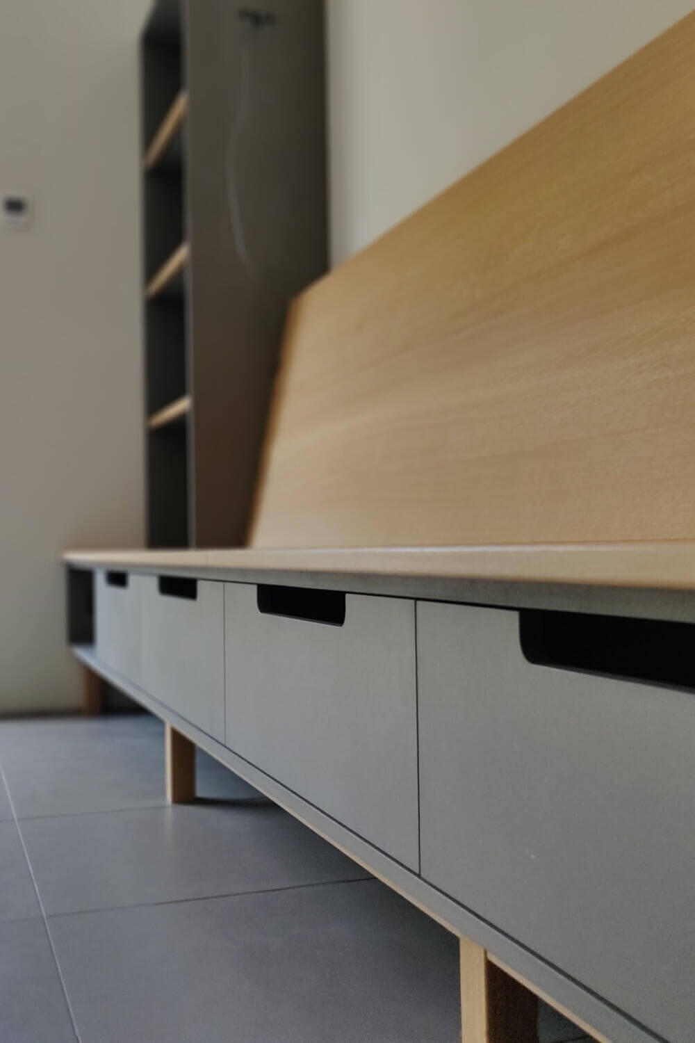 Minimalist Bench Seat with Integrated Low Level Drawers Bespoke minimalist oak and grey Valchromat bench seat with low level drawers sitting on solid oak legs by Fundi Joinery Edinburgh