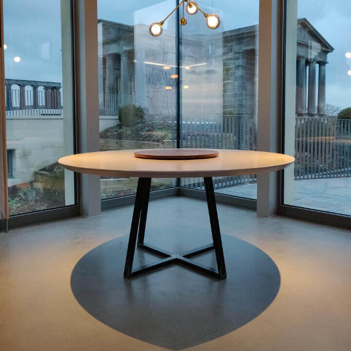 Bespoke Modern Round Timber Dinning Room Table Bespoke modern round birch table top with brass inlay and a walnut lazy Susan. A bespoke raw steel geometric metal base, Made by Fundi Joinery in Edinburgh